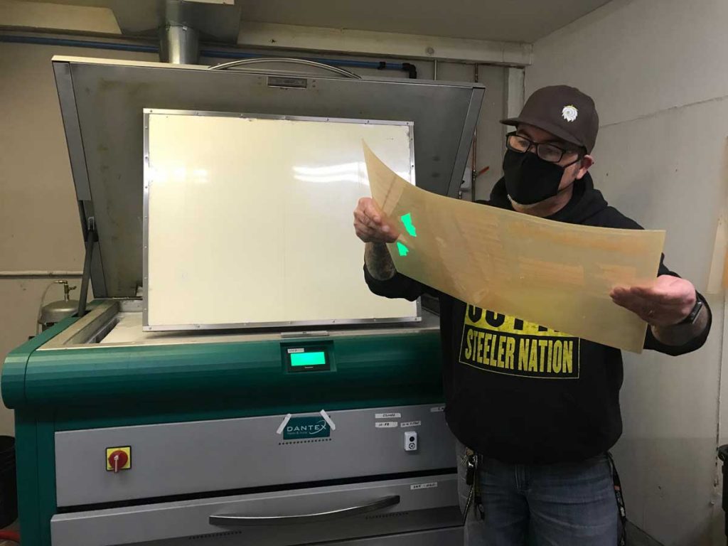 John Stanford of Rose City Label inspecting a plate